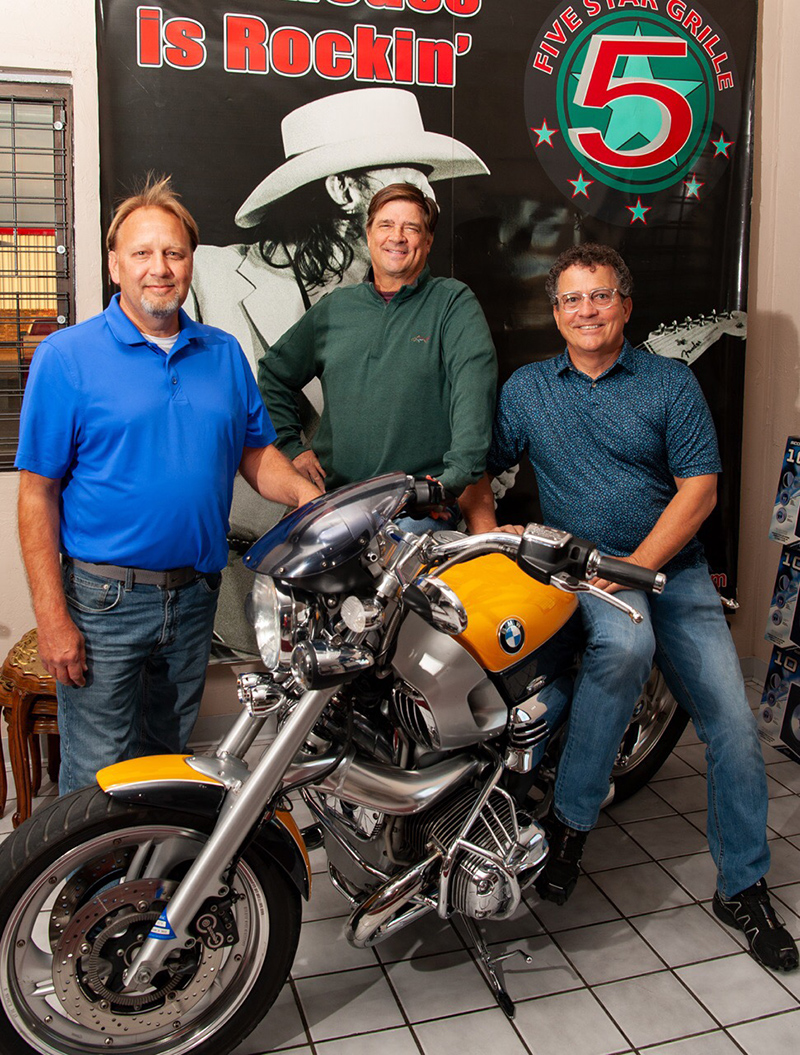 Ricky Stapleton and friends with a BMW motorcycle.